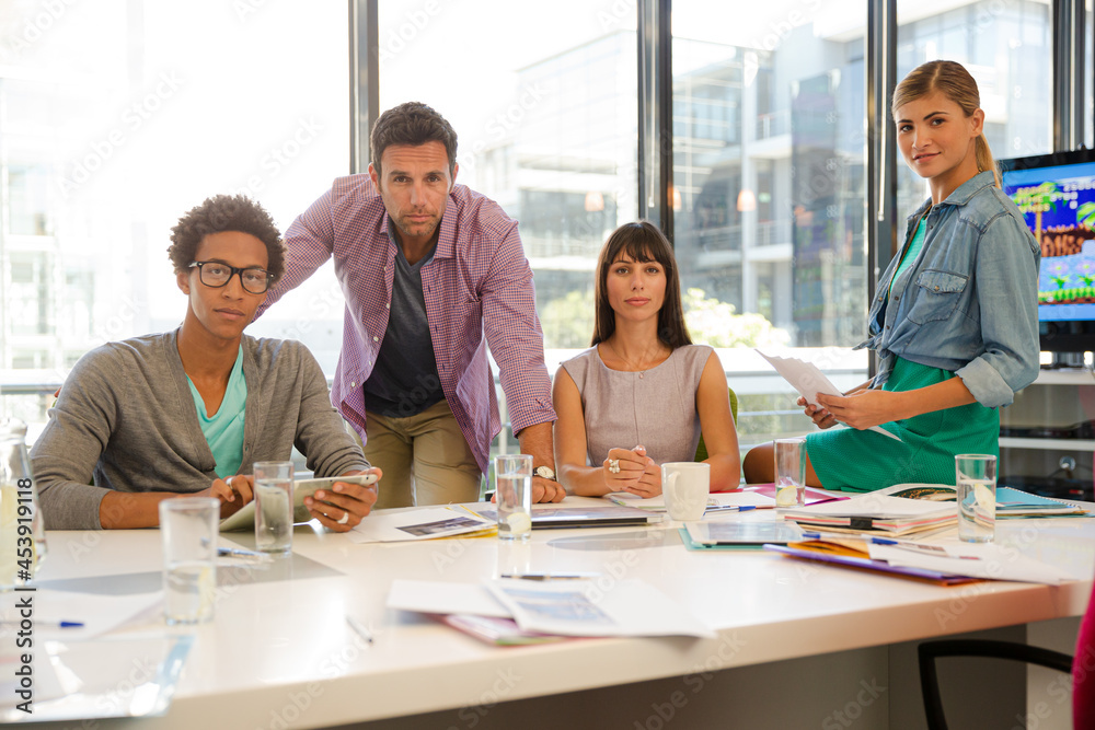 Portrait of smiling business people in conference room