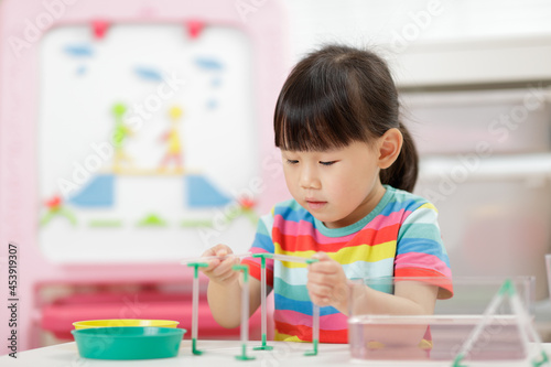 young girl play science experiments for homeschooling