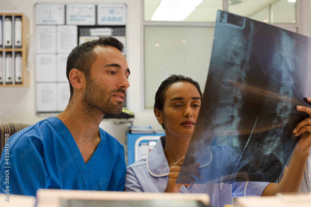 Surgeons examining x-rays in hospital