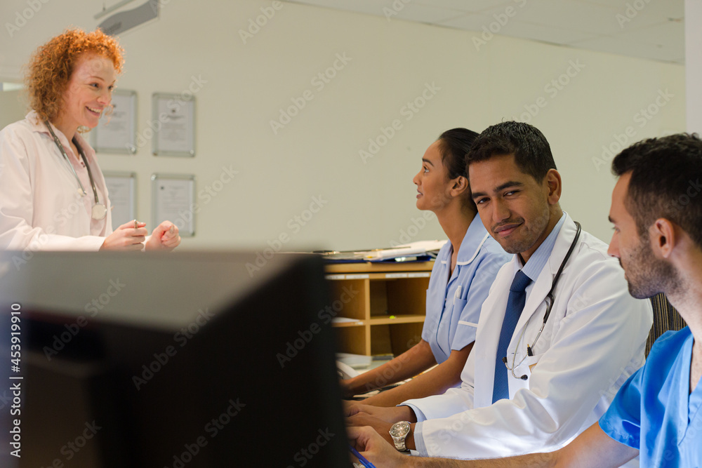 Hospital staff talking at front desk