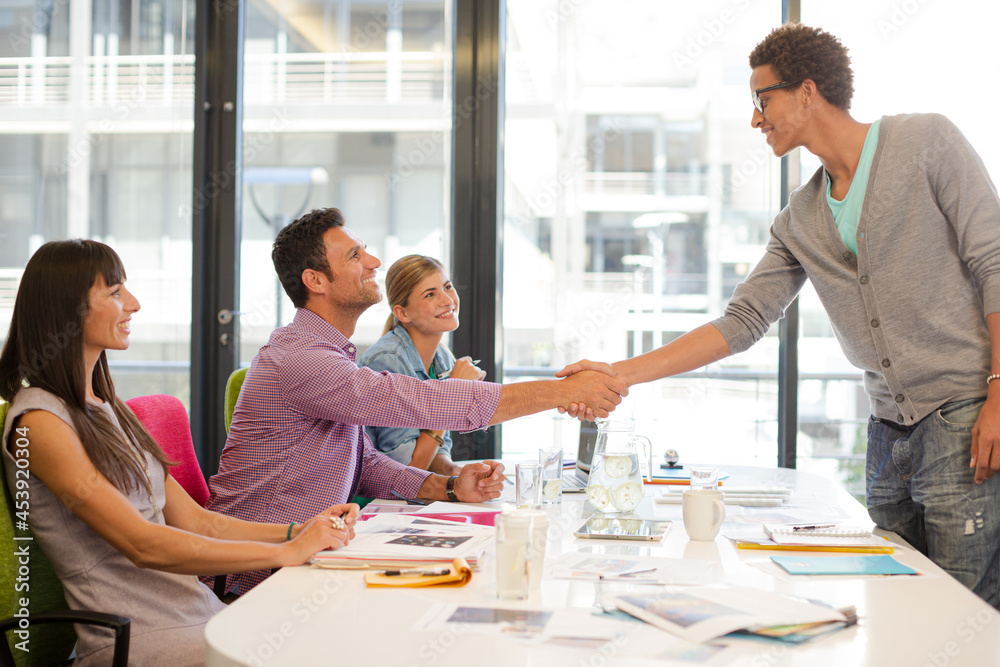 Business people shaking hands in meeting Business people shaking hands in meeting