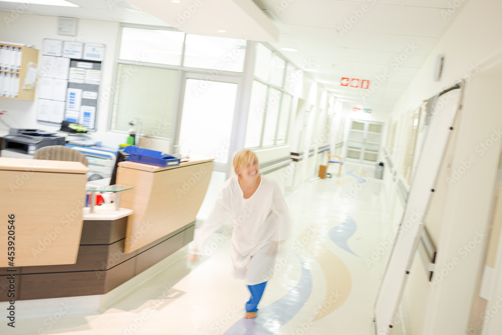 Nurse rushing in hospital hallway Nurse rushing in hospital hallway