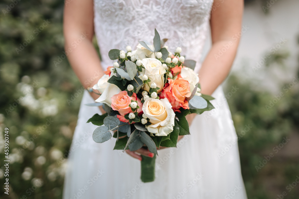 Bride holding beautiful wedding bouquet in her hands close-up Bride holding beautiful wedding bouquet in her hands close-up