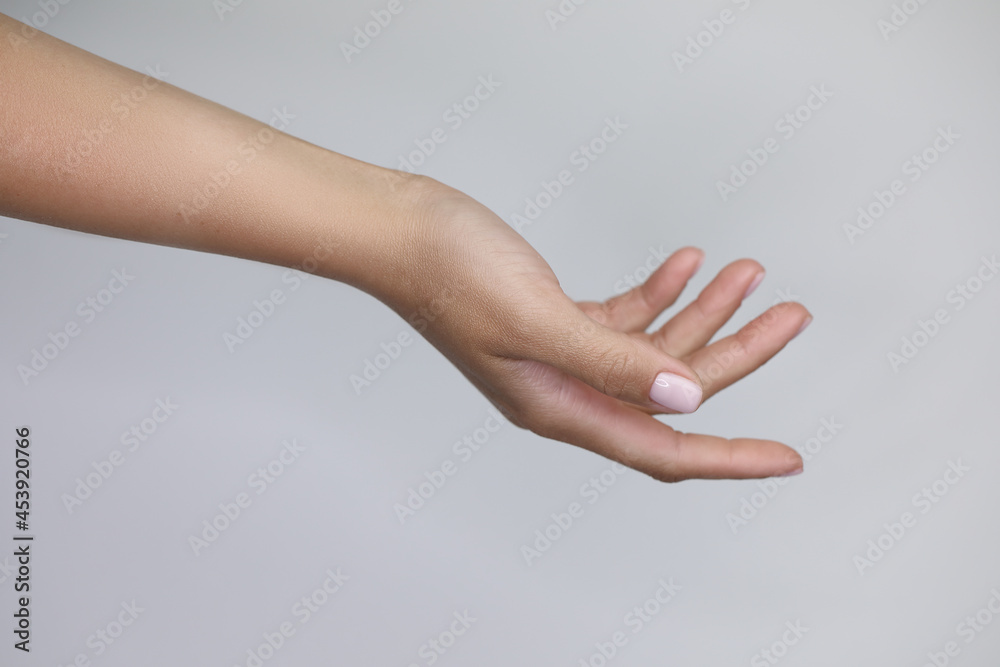 beautiful hands with manicured nude nails manicure.