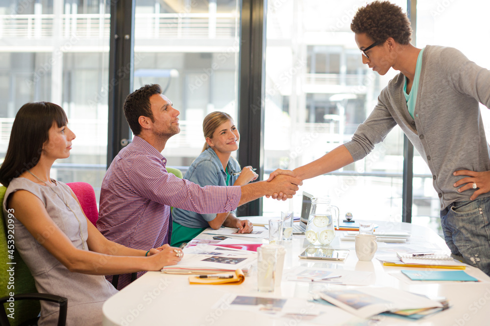 Business people shaking hands in meeting Business people shaking hands in meeting