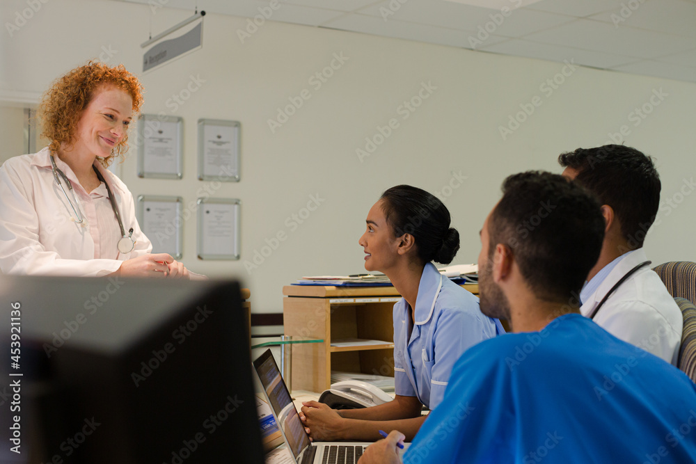 Hospital staff talking at front desk Hospital staff talking at front desk