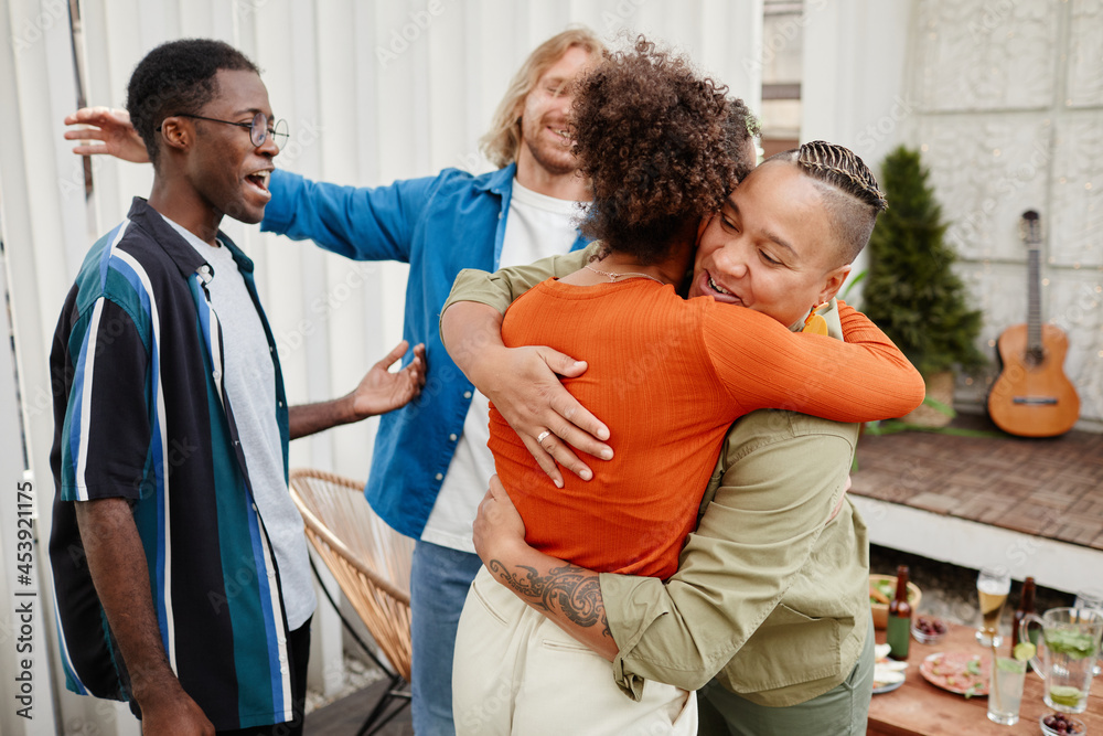 Diverse group of modern young friends greeting each other at rooftop party, copy space Diverse group of modern young friends greeting each other at rooftop party, copy space