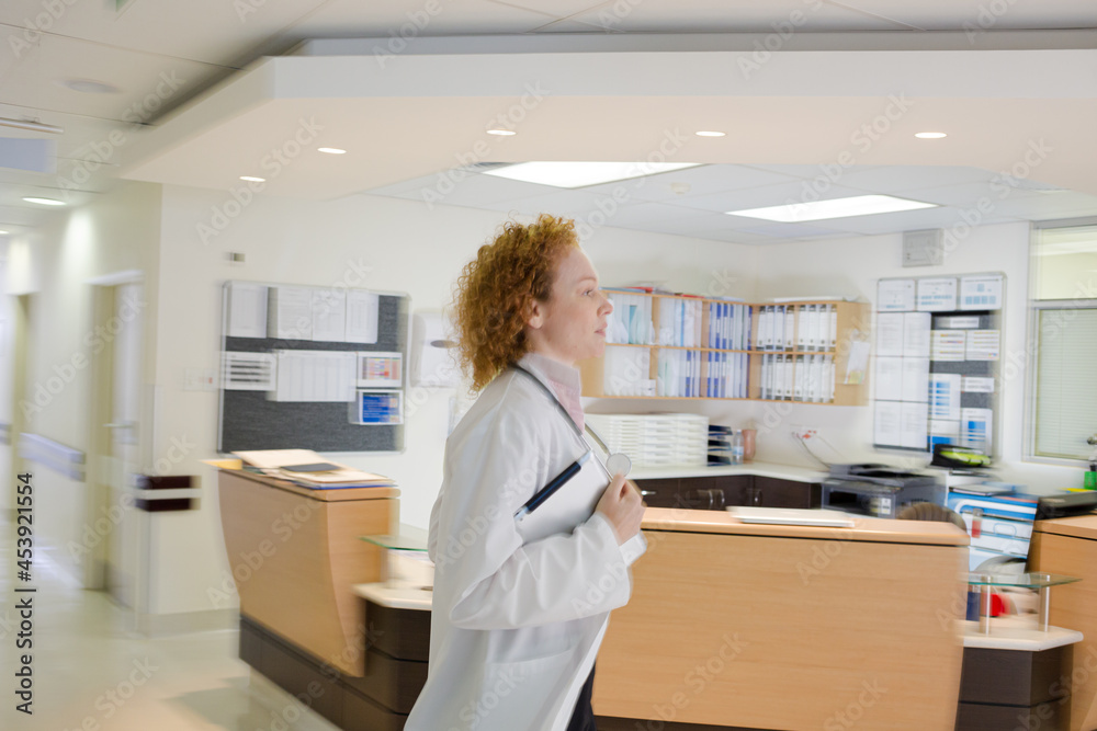 Doctor rushing in hospital hallway