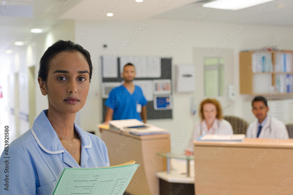 Nurse standing in hospital hallway Nurse standing in hospital hallway