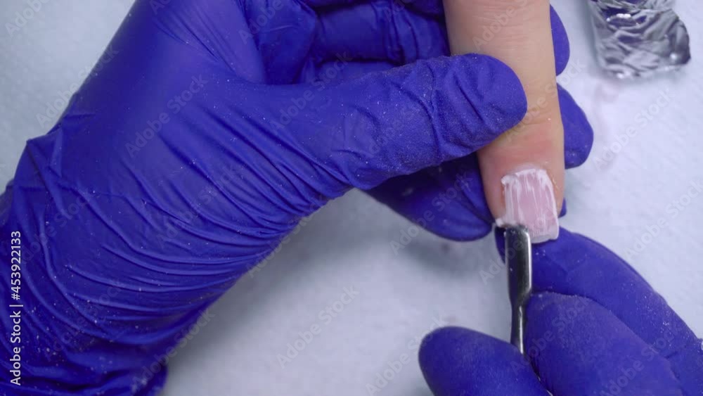 The procedure for removing gel polish from nails in progress. Gel nail polish remover foils on woman's hands. The procedure for removing gel polish from nails in progress. Gel nail polish remover foils on woman's hands.