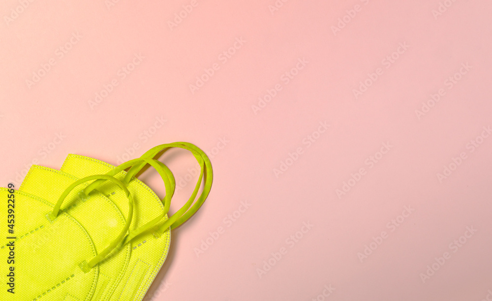 FFP2 face mask to protect from infectious covid-19 on pastel pink surface. FFP2 face mask to protect from infectious covid-19 on pastel pink surface.