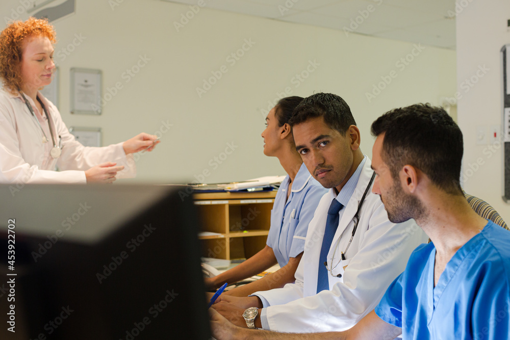 Fototapeta premium Hospital staff talking at front desk