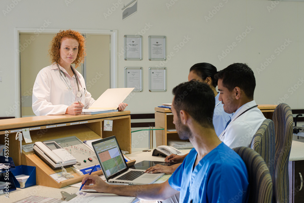 Fototapeta premium Hospital staff talking at front desk