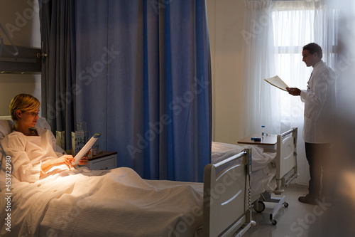Doctor using cell phone in hospital room