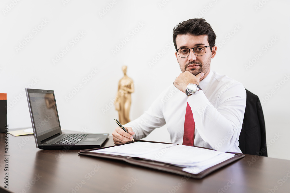 Businessman working in office with laptop and documents on his desk, consultant lawyer concept. Businessman working in office with laptop and documents on his desk, consultant lawyer concept.