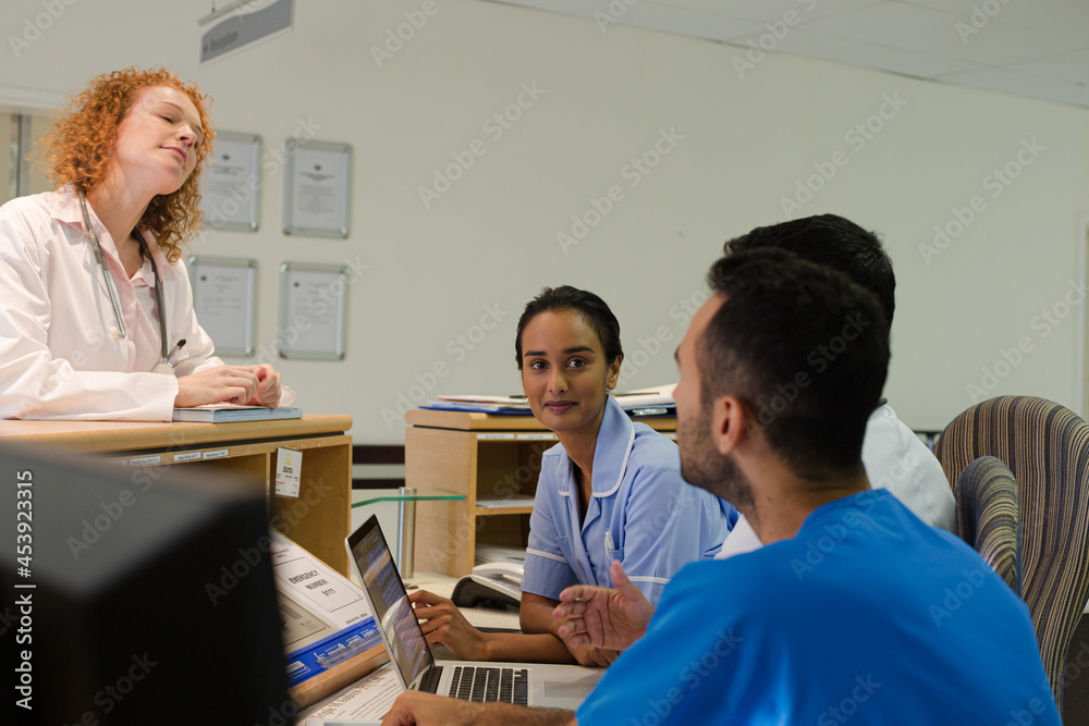 Fototapeta premium Hospital staff talking at front desk