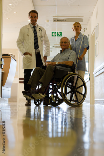 Doctor and nurse with older patient in hospital