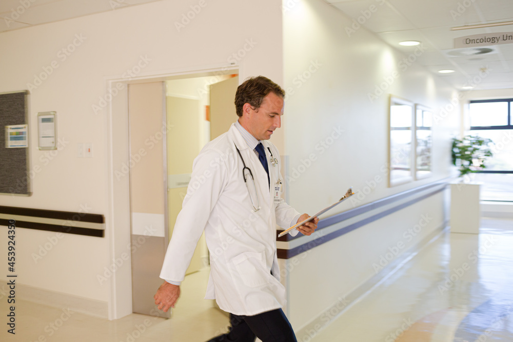 Doctor rushing in hospital hallway