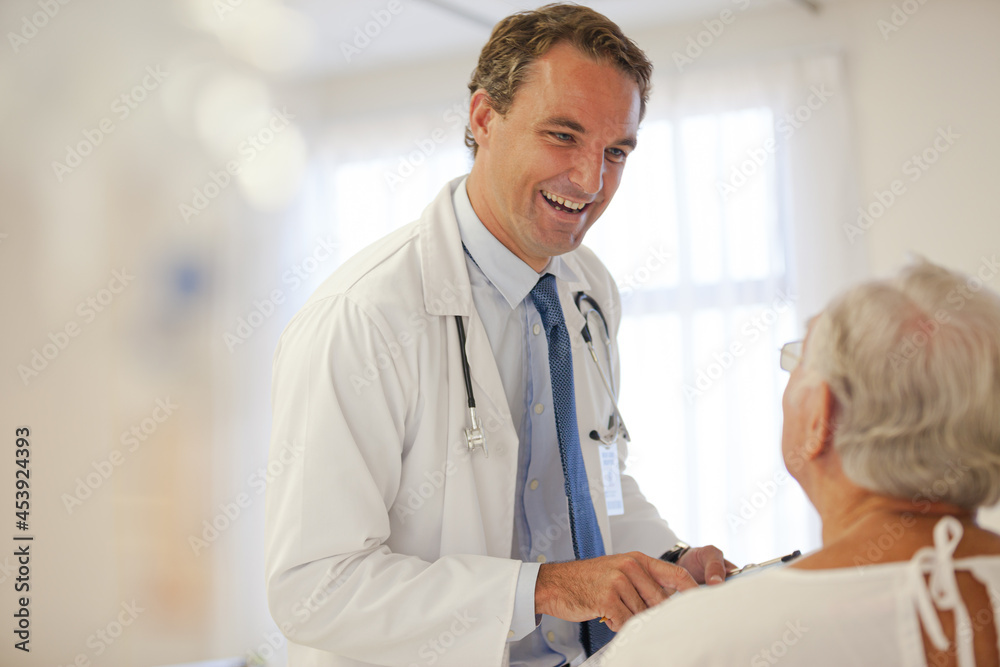 Fototapeta premium Doctor talking to older patient in hospital