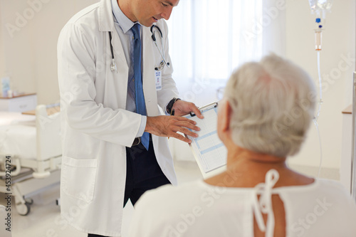 Doctor talking to older patient in hospital