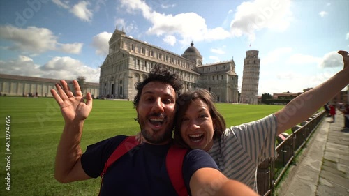 Travel tourists friends taking photo selfi with smartphone in Pisa, Tuscany. happy couple in love traveling in Europe having fun taking self-portrait picture in Pisa by Leaning Tower of Pisa, Italy.