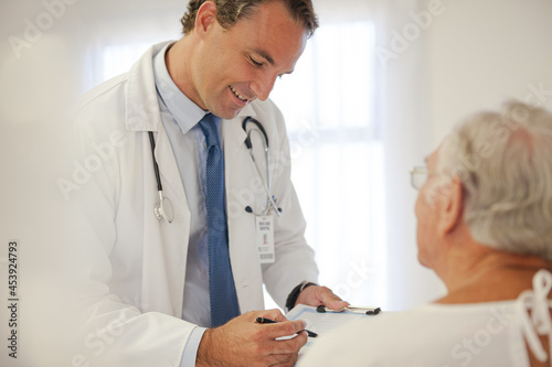 Doctor talking to older patient in hospital