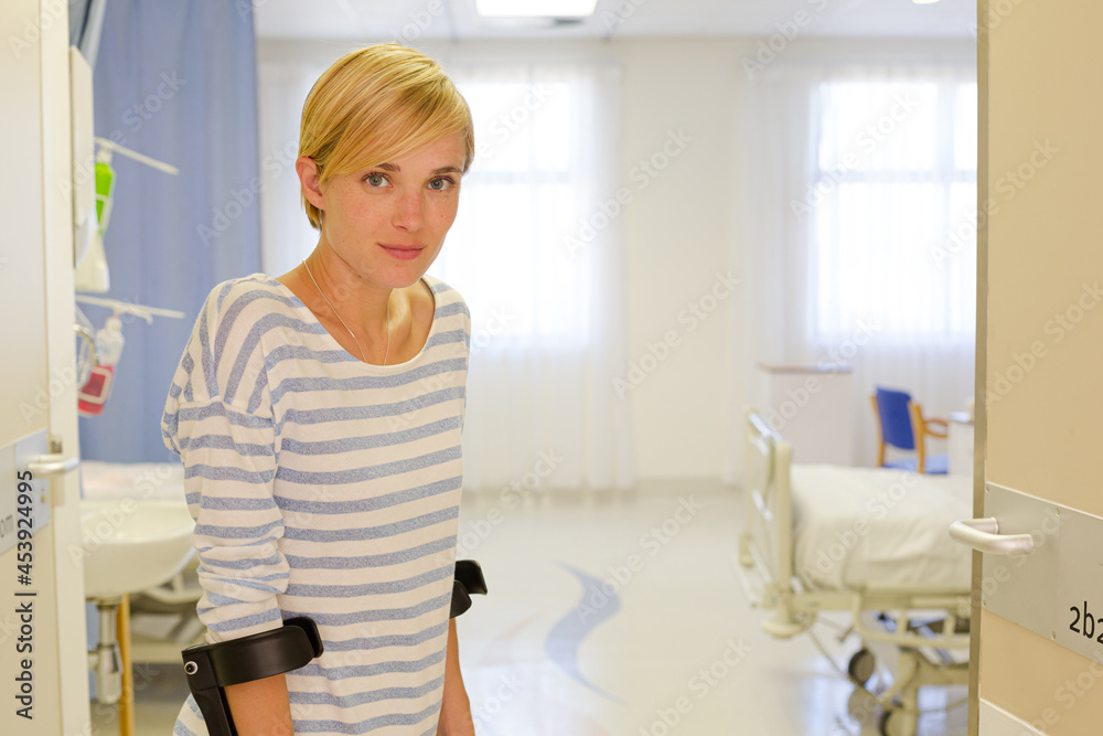 Patient using crutches in hospital room Patient using crutches in hospital room
