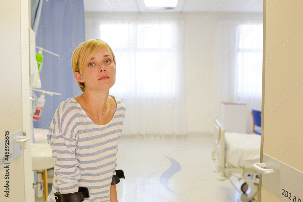 Patient using crutches in hospital room Patient using crutches in hospital room