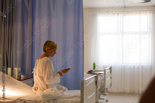 Patient wearing gown on hospital bed