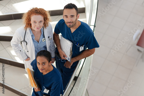 Doctor and nurses on hospital steps