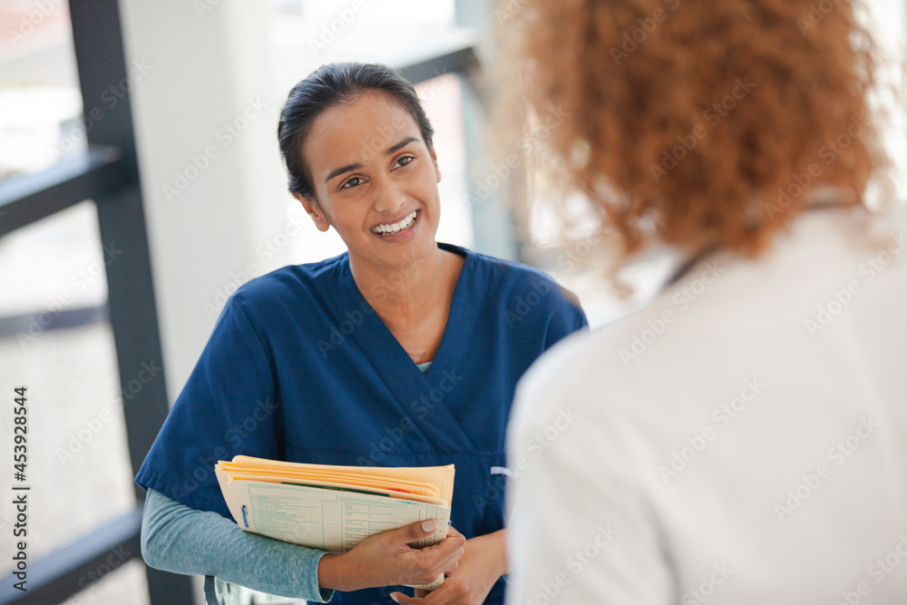 Fototapeta premium Doctor and nurse talking in hospital hallway