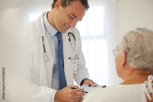 Doctor talking to older patient in hospital