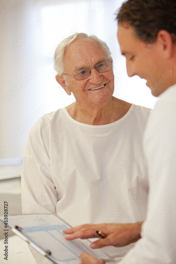 Doctor talking to older patient in hospital