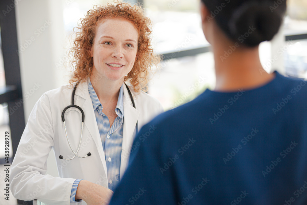 Doctor and nurse talking in hospital hallway Doctor and nurse talking in hospital hallway