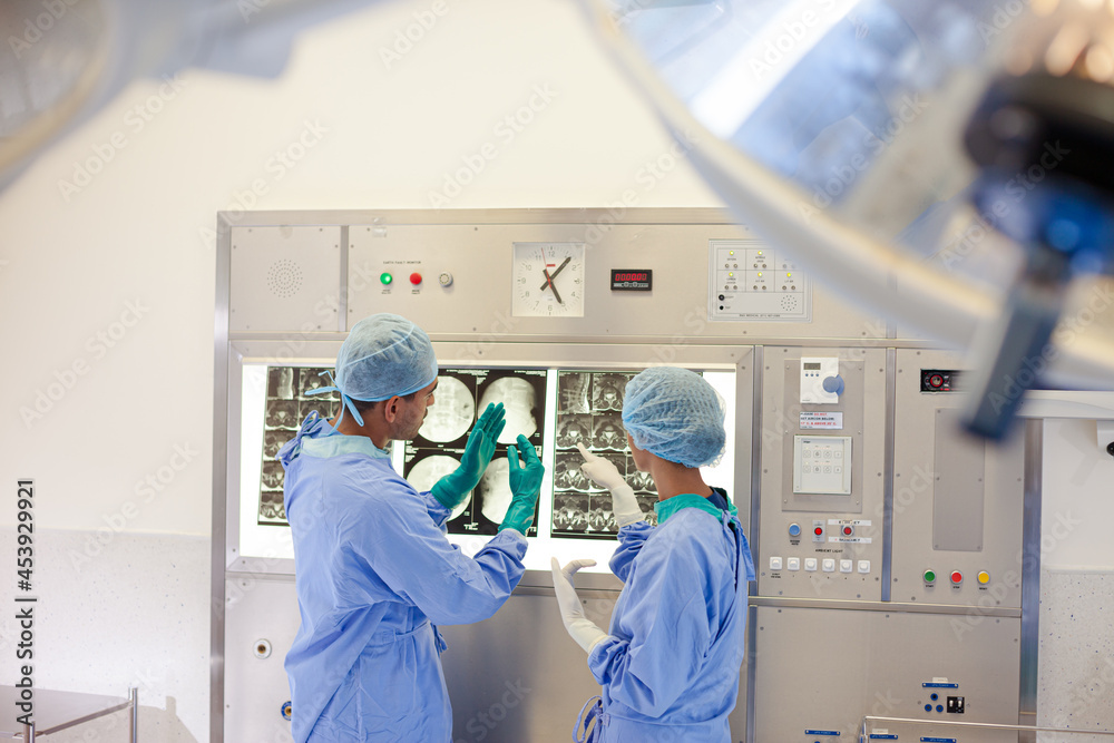 Surgeons examining x-rays in hospital