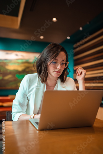 woman working on laptop in cafe
