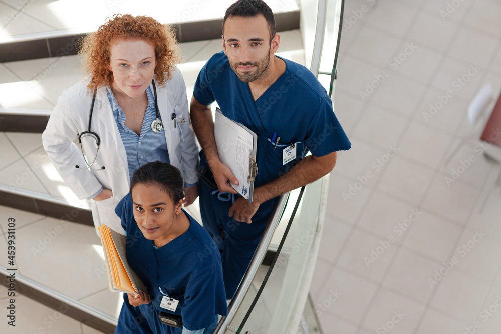 Doctor and nurses on hospital steps