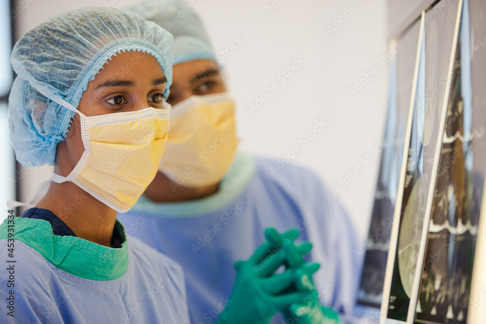 Surgeons examining x-rays in hospital Surgeons examining x-rays in hospital