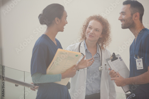 Hospital staff talking near staircase