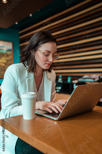 woman working on laptop in cafe