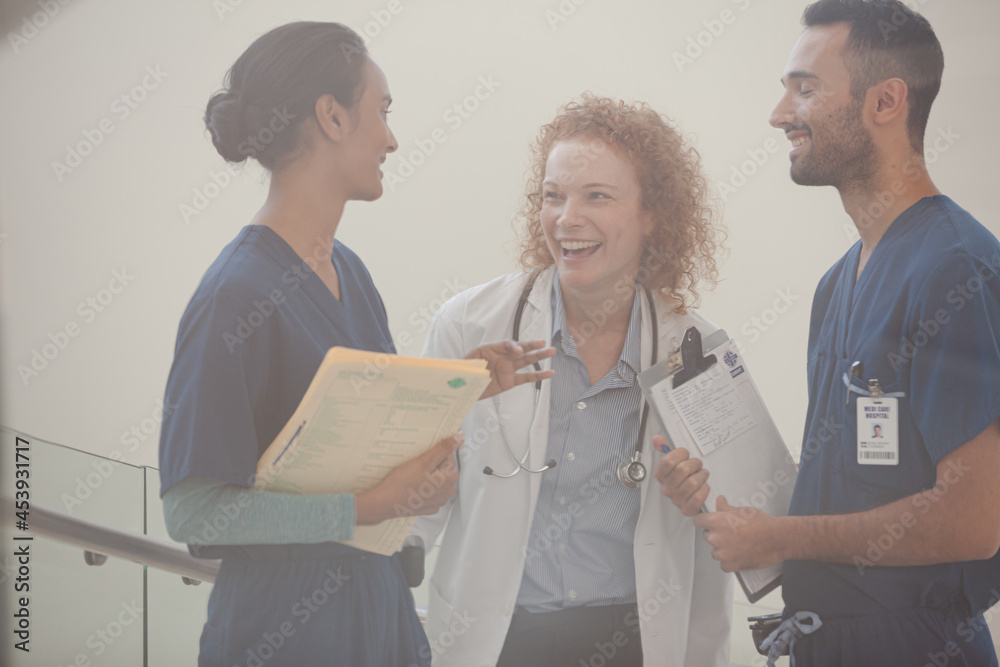 Fototapeta premium Hospital staff talking near staircase
