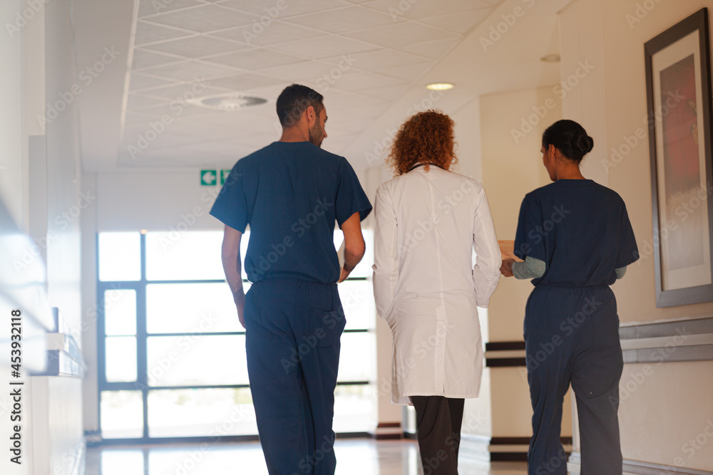 Hospital staff walking in hallway Hospital staff walking in hallway