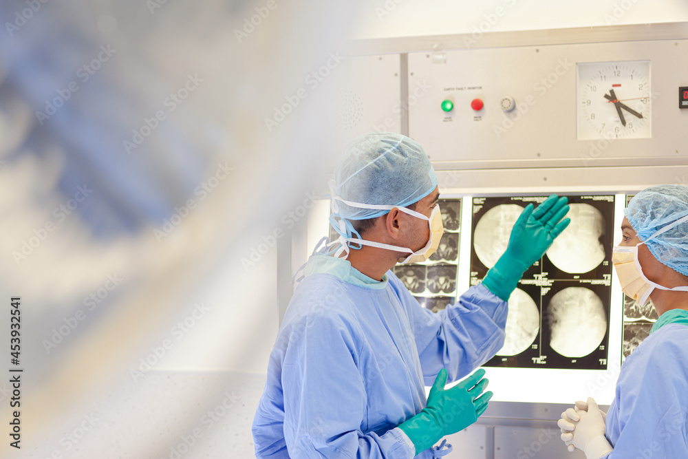 Surgeons examining x-rays in hospital Surgeons examining x-rays in hospital
