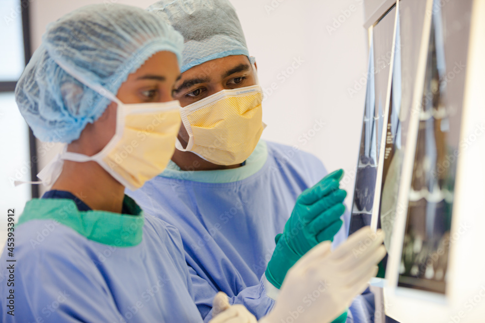 Surgeons examining x-rays in hospital Surgeons examining x-rays in hospital