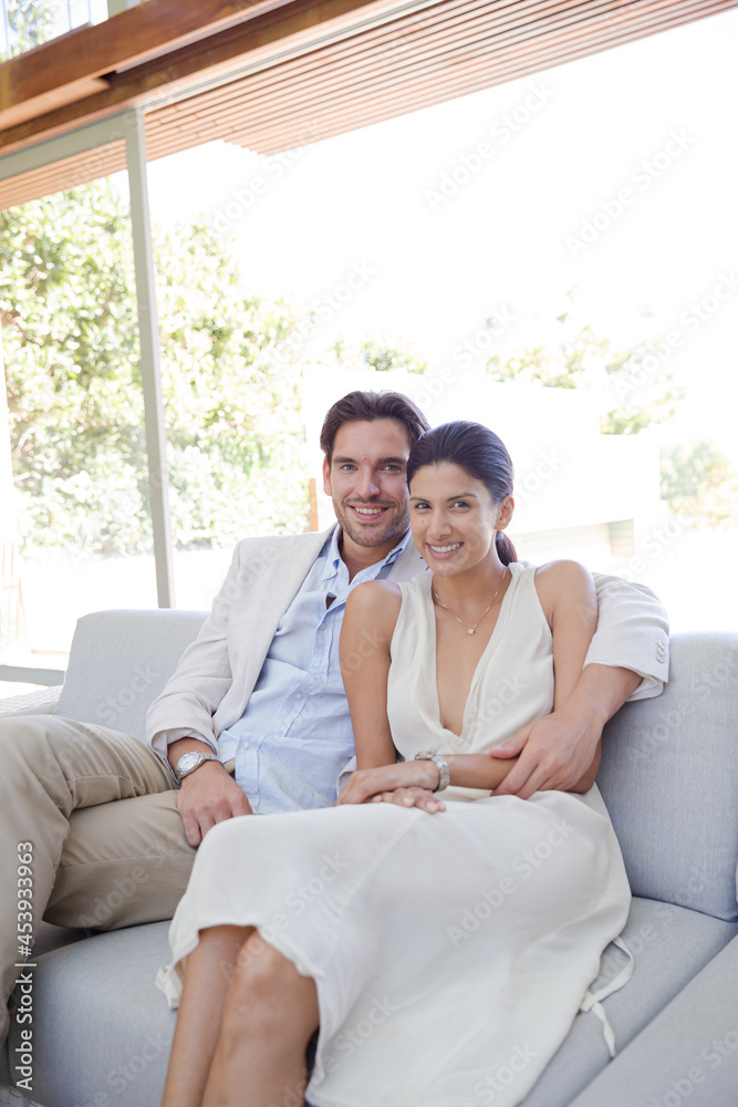 Portrait of smiling couple on sofa Portrait of smiling couple on sofa
