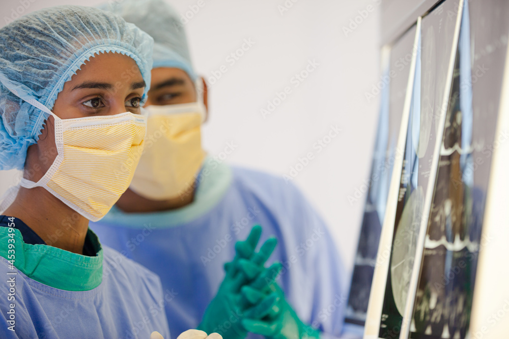 Surgeons examining x-rays in hospital Surgeons examining x-rays in hospital