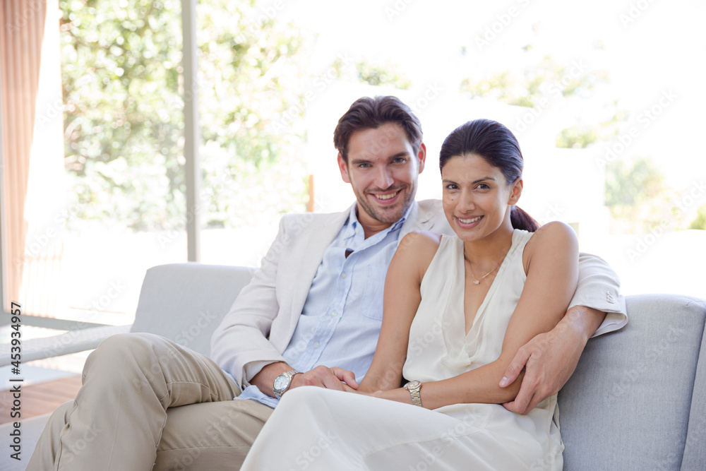 Portrait of smiling couple on sofa Portrait of smiling couple on sofa
