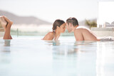Couple relaxing together in swimming pool