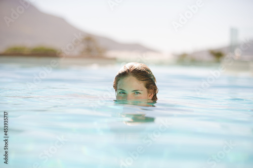 Close up of woman relaxing in swimming pool