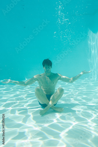 Man posing underwater in swimming pool © KOTO
